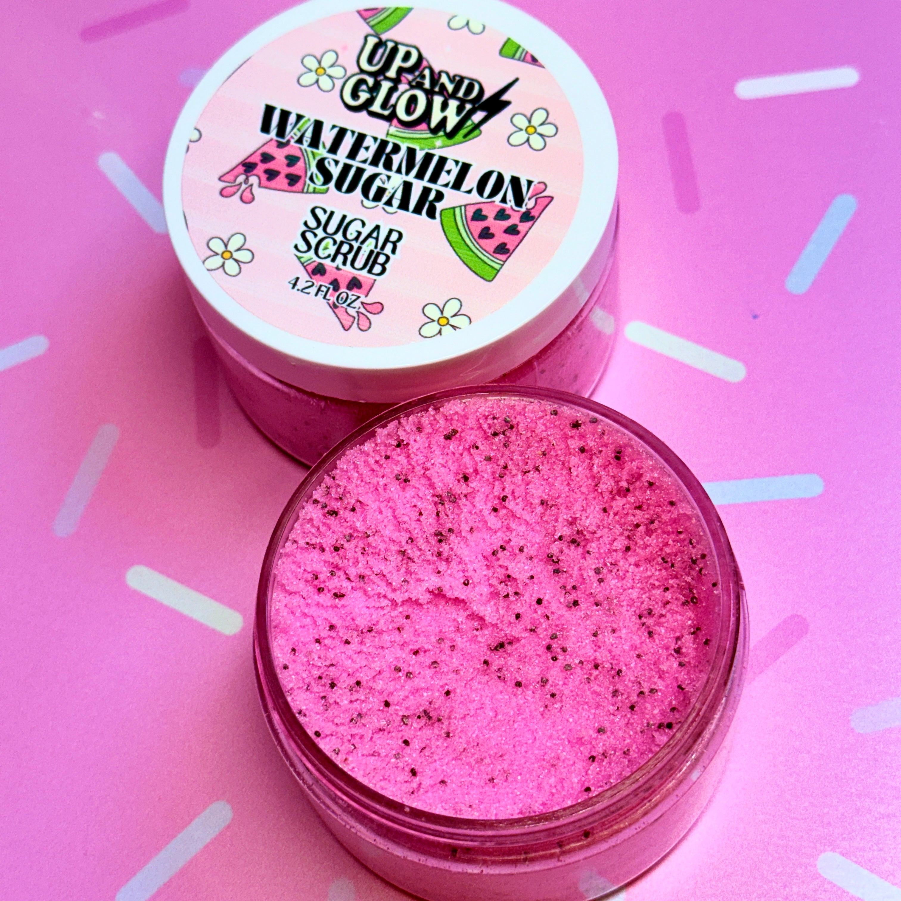 Pink watermelon sugar scrub with a visible brand label on a pink background. Natural sugar scrub 
