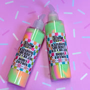 Two bottles of 'Up & Glow' rainbow sherbet ice cream body lotion on a pink background with white and purple sprinkles.