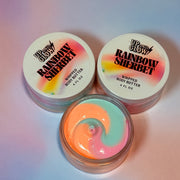 Two containers of 'Rainbow Sherbet' whipped body butter with a third container open showing the colorful texture.