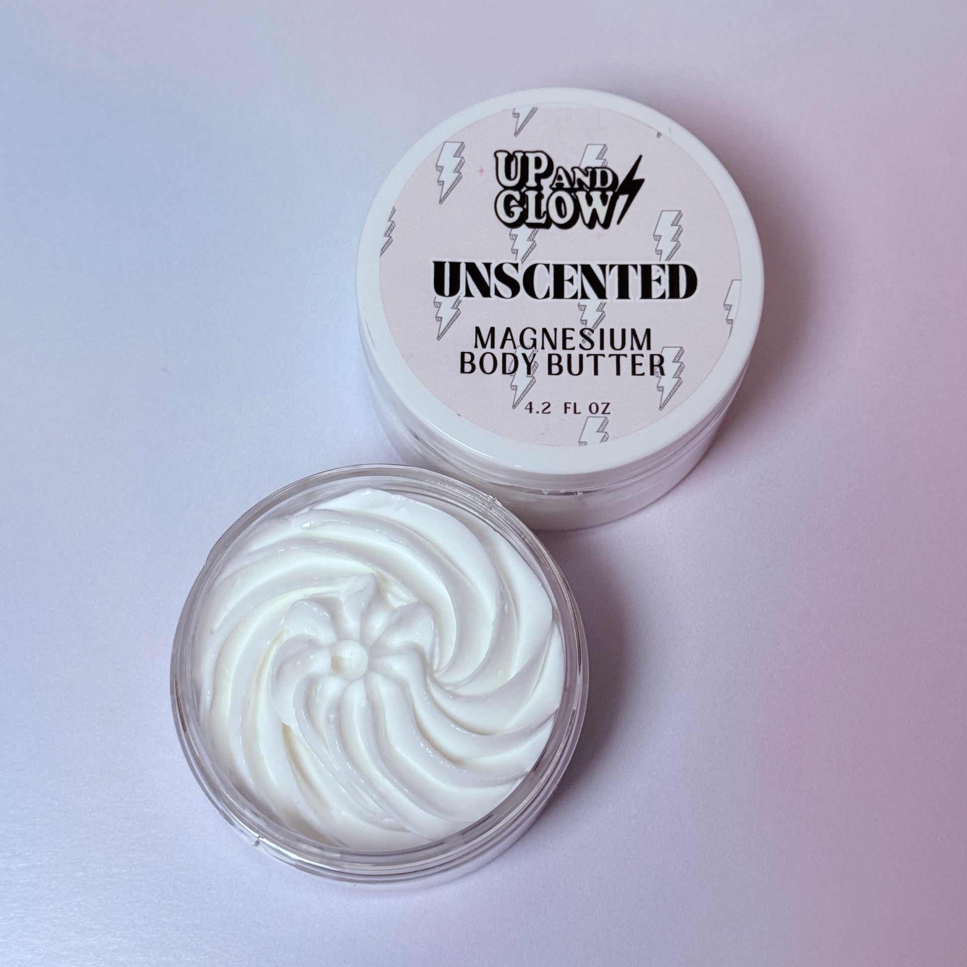 Unscented magnesium body butter with 'Up and Glow' branding on a light pink background