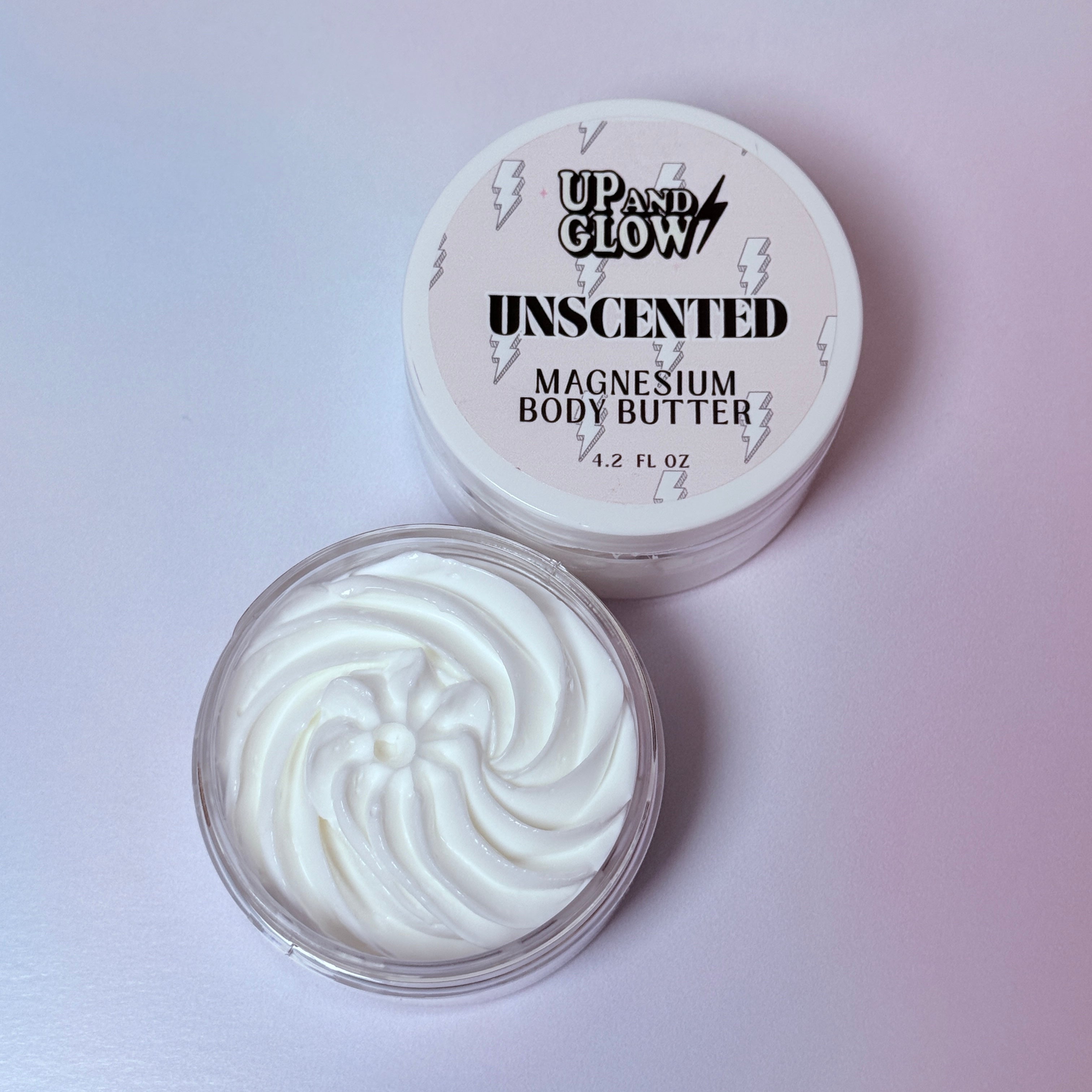 Unscented magnesium body butter with 'Up and Glow' branding on a light pink background