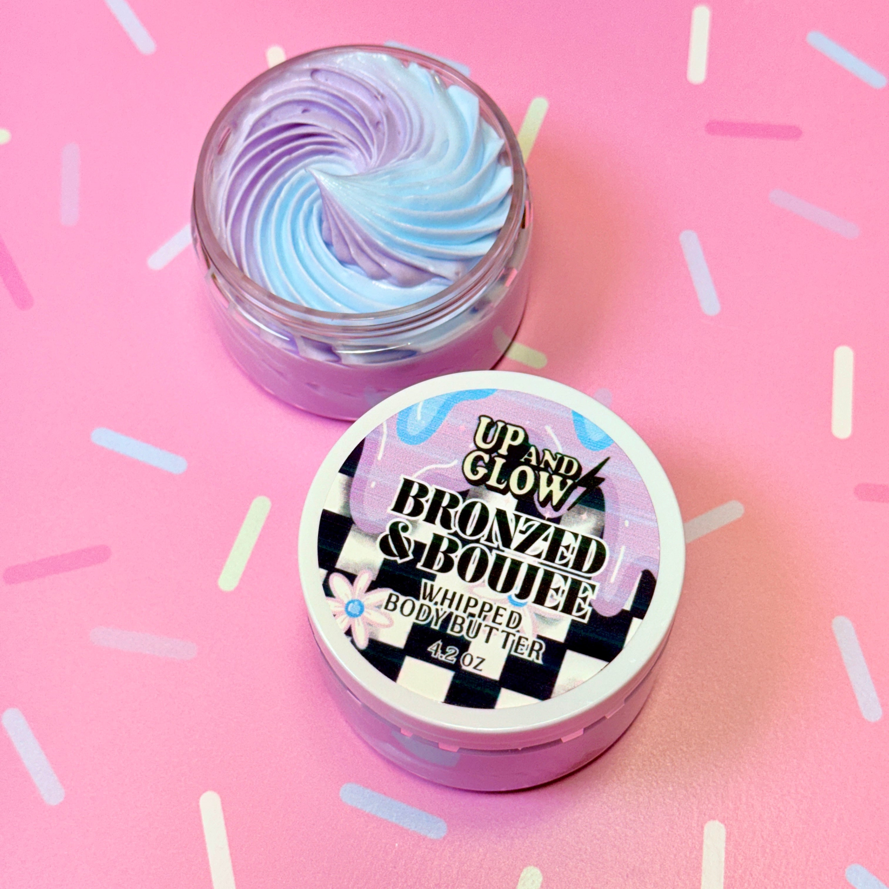 Up and Glow Bronzed & Boujee whipped body butter jar on a pink background
